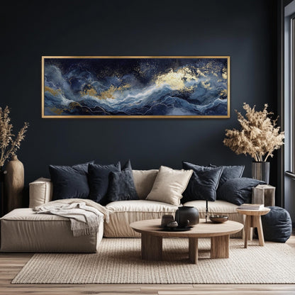 a modern living room with a large, dark blue abstract painting hanging on the wall above a beige sofa. The sofa is adorned with throw pillows and a wooden coffee table. The room also features a large window, a side table, and a potted plant, creating a cozy and stylish atmosphere.