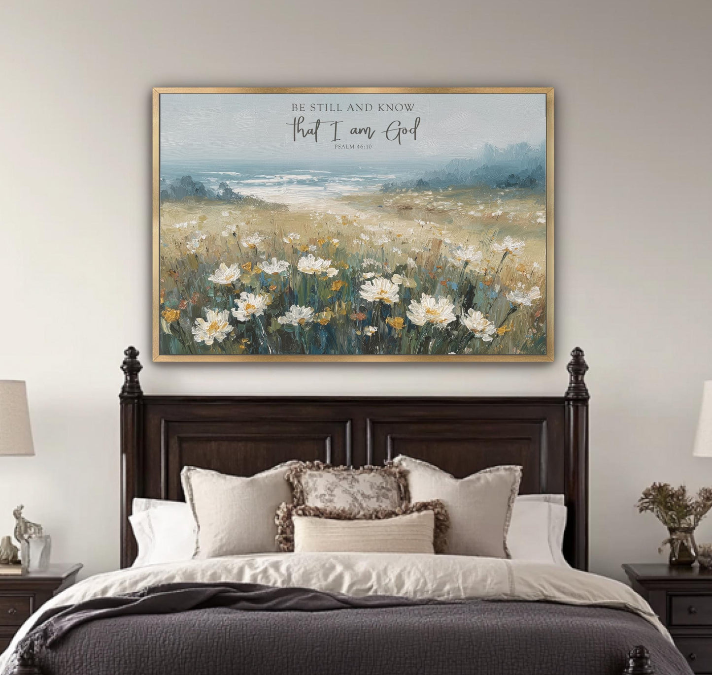 a large painting of a field of flowers hanging above a bed with a wooden headboard.