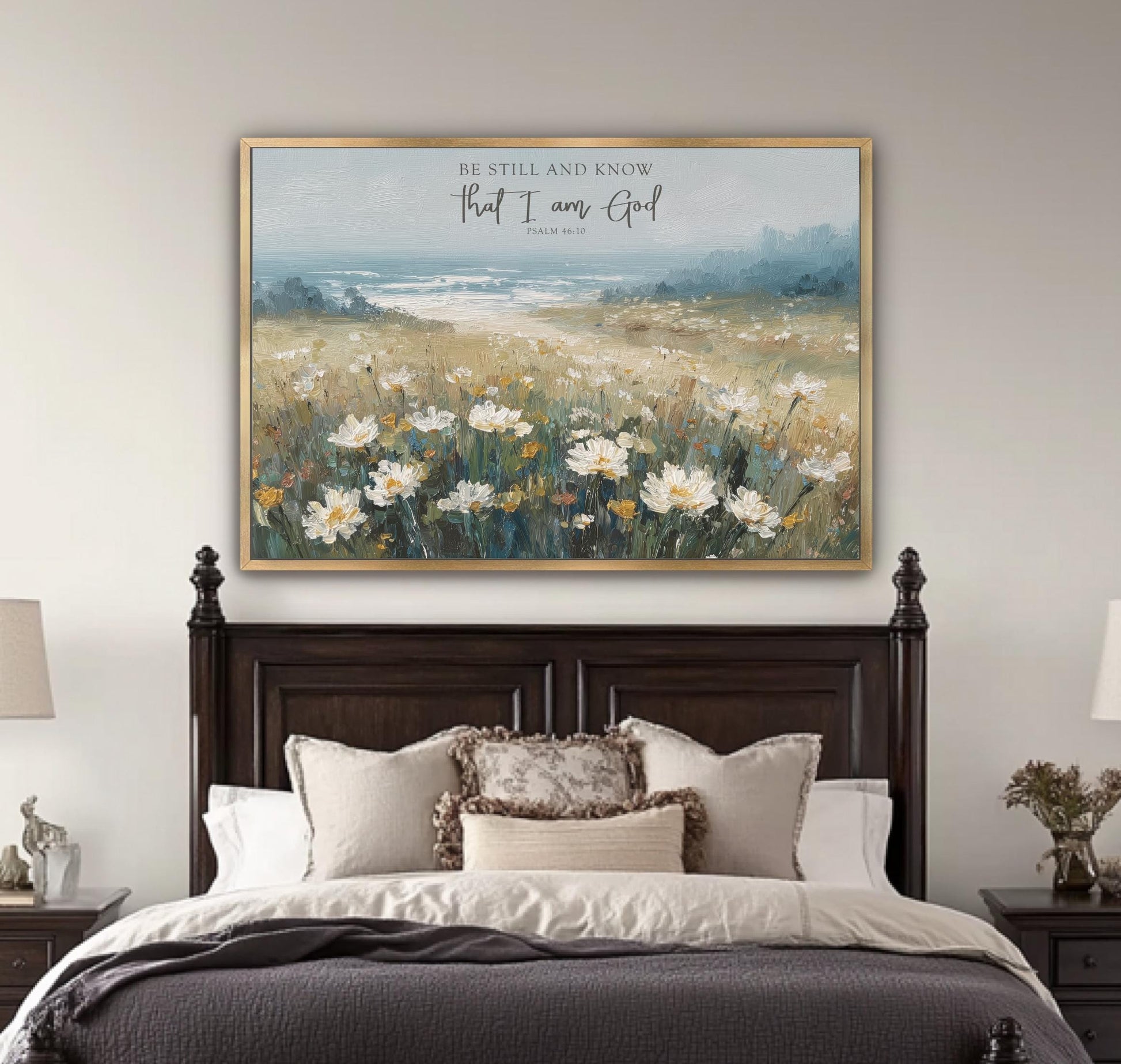 a large painting of a field of flowers hanging above a bed with a wooden headboard.