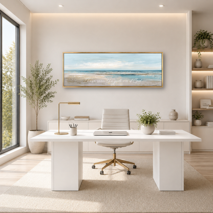 A modern and minimalist office space with a large window, a white desk, a white chair, and a framed landscape painting on the wall.