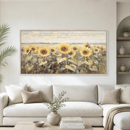 a large painting of a field of sunflowers hanging on a wall above a white sofa in a living room.