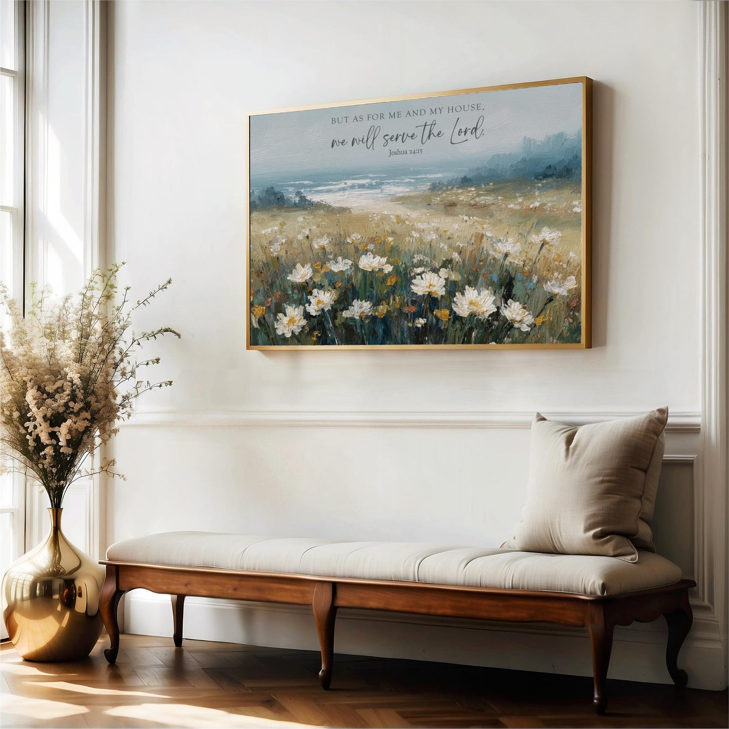 a serene indoor setting with a large painting of a field of flowers hanging on the wall above a wooden bench. The painting is framed in gold and depicts a peaceful landscape with a field of white flowers. The bench is positioned in front of the painting, creating a cozy and inviting atmosphere.