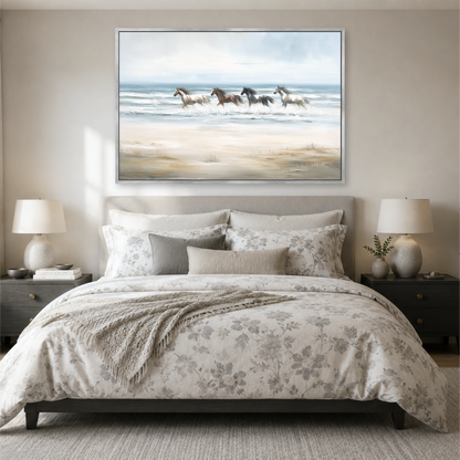 a serene bedroom scene with a large bed, a nightstand on each side, and a framed painting of horses running across a beach above the bed.