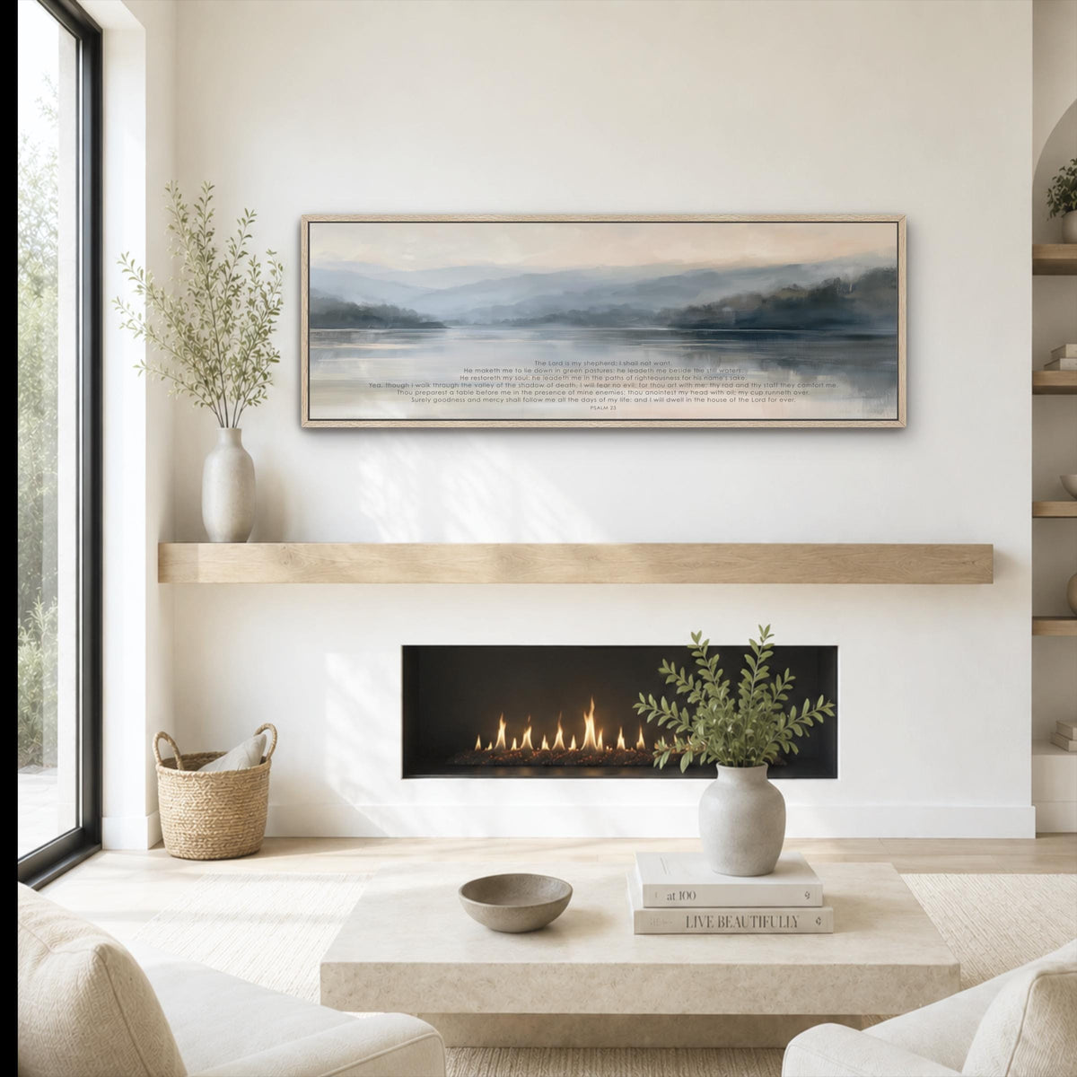 a cozy living room with a fireplace, a coffee table, and a painting hanging on the wall above it. The room has a minimalist and modern design, with a large window providing natural light and a view of the outdoors. The fireplace is lit, creating a warm and inviting atmosphere. The coffee table is adorned with a vase of greenery and a bowl, adding a touch of nature and elegance to the space. The painting above the fireplace adds an artistic element to the room, complementing the overall design.