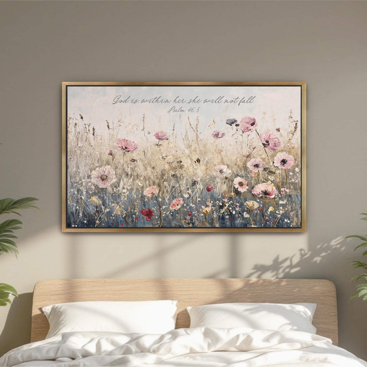 A framed painting of a field of flowers hangs on a wall above a bed with white pillows.
