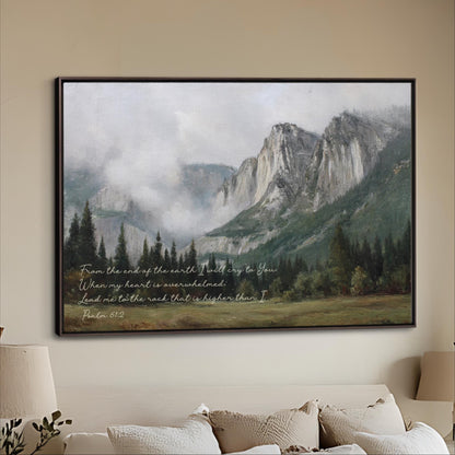 A framed painting depicting a mountainous landscape with a misty, hazy atmosphere. The painting is hung on a wall above a couch, creating a serene and peaceful atmosphere in the room.