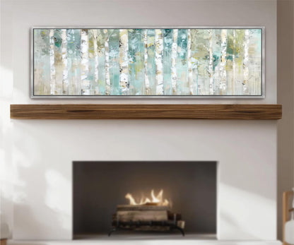 a fireplace with a warm fire burning inside, and above it is a large framed artwork depicting a forest scene with birch trees.