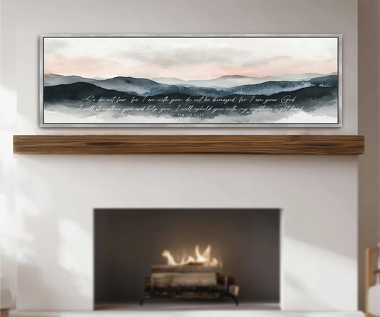 a fireplace with a warm fire burning inside, and above it is a framed painting depicting a serene landscape with mountains and a cloudy sky.