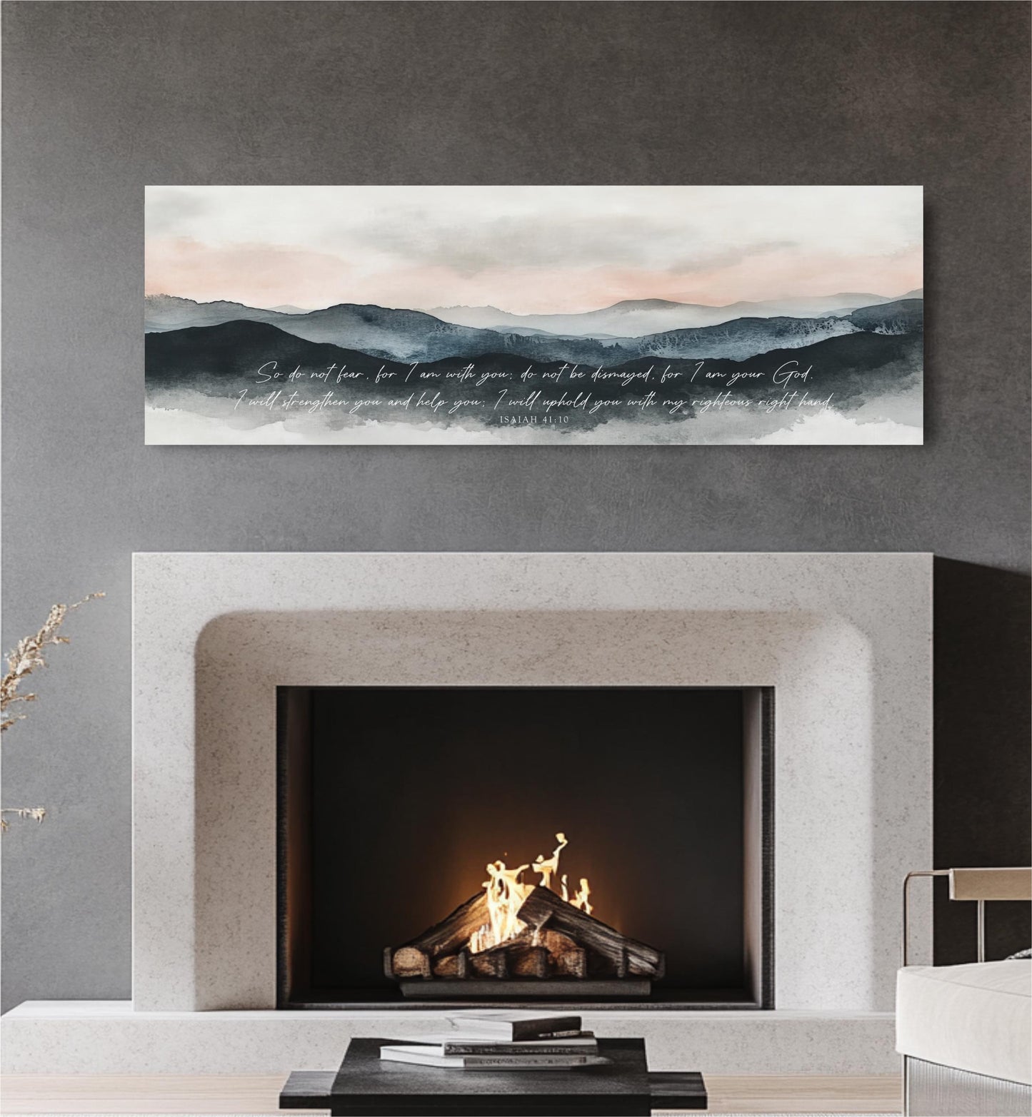 a fireplace with a lit fire, and above it is a painting depicting a mountain landscape with a text overlay.