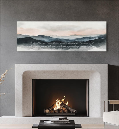 a fireplace with a lit fire, and above it is a painting depicting a mountain landscape with a text overlay.