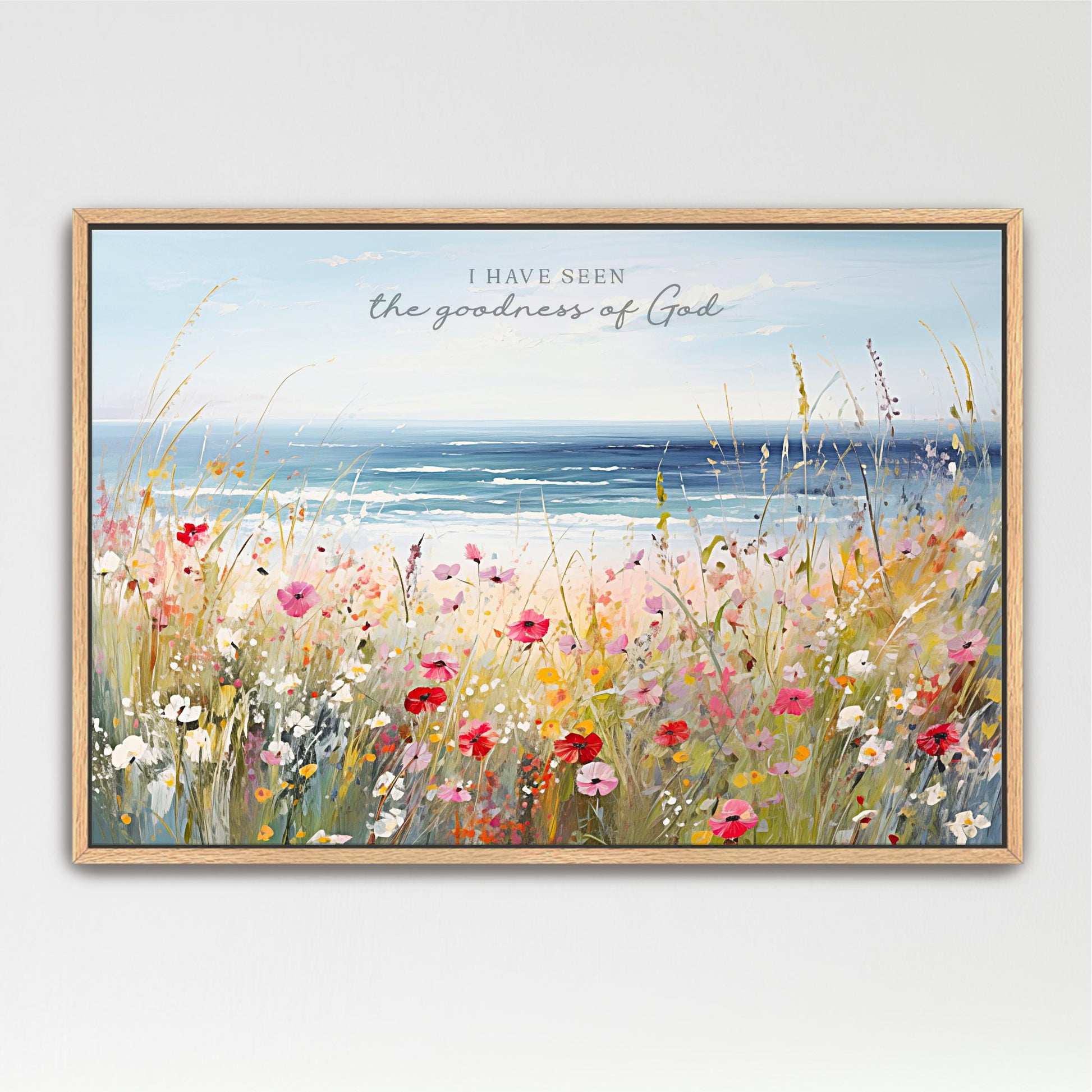 The image is a framed painting depicting a vibrant field of colorful wildflowers, with a serene body of water in the background.