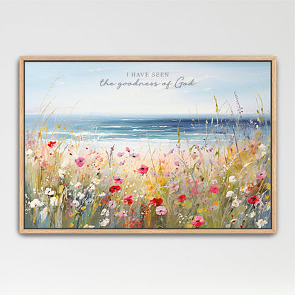 The image is a framed painting depicting a vibrant field of colorful wildflowers, with a serene body of water in the background.