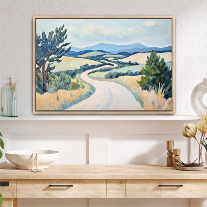 a large landscape painting hanging on a wall above a wooden table with various decorative items on it.