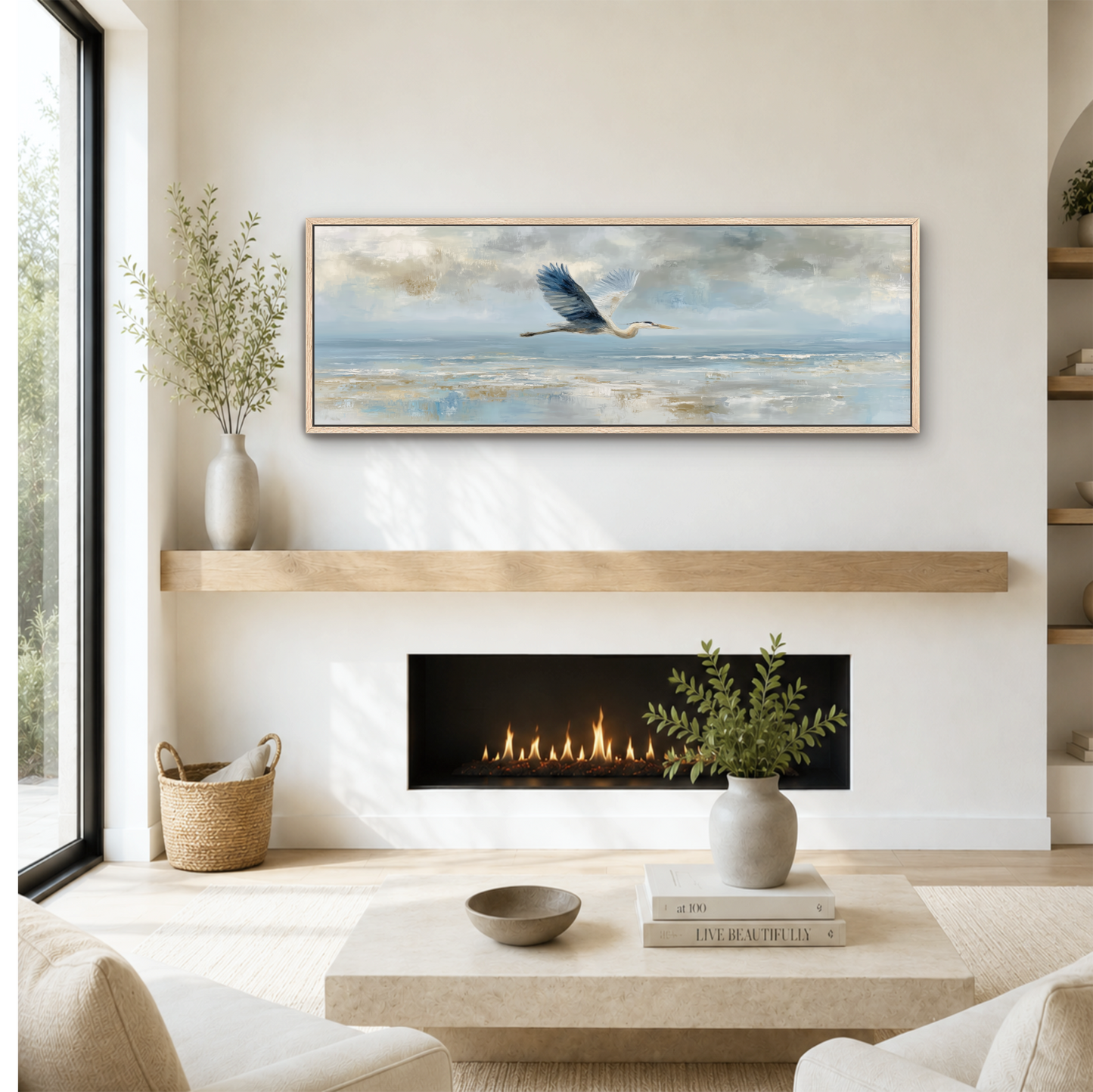 a cozy living room with a fireplace, a coffee table, and a painting of a bird in flight above it. The room has a minimalist and modern design, with a large window providing natural light and a view of the outdoors.
