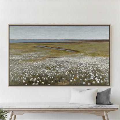 a large painting of a field with white flowers hanging on a wall above a wooden bench.