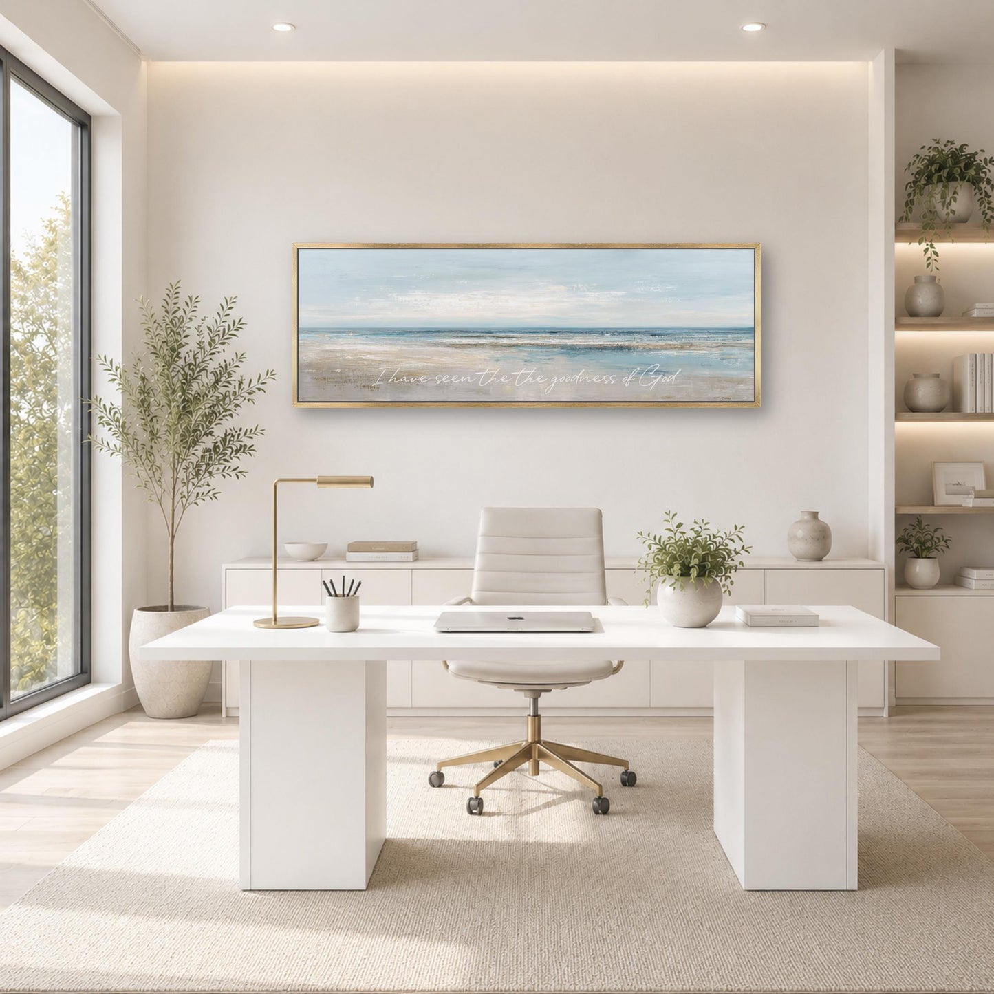 A modern and minimalist office space with a large window, white desk, and a framed landscape painting on the wall.