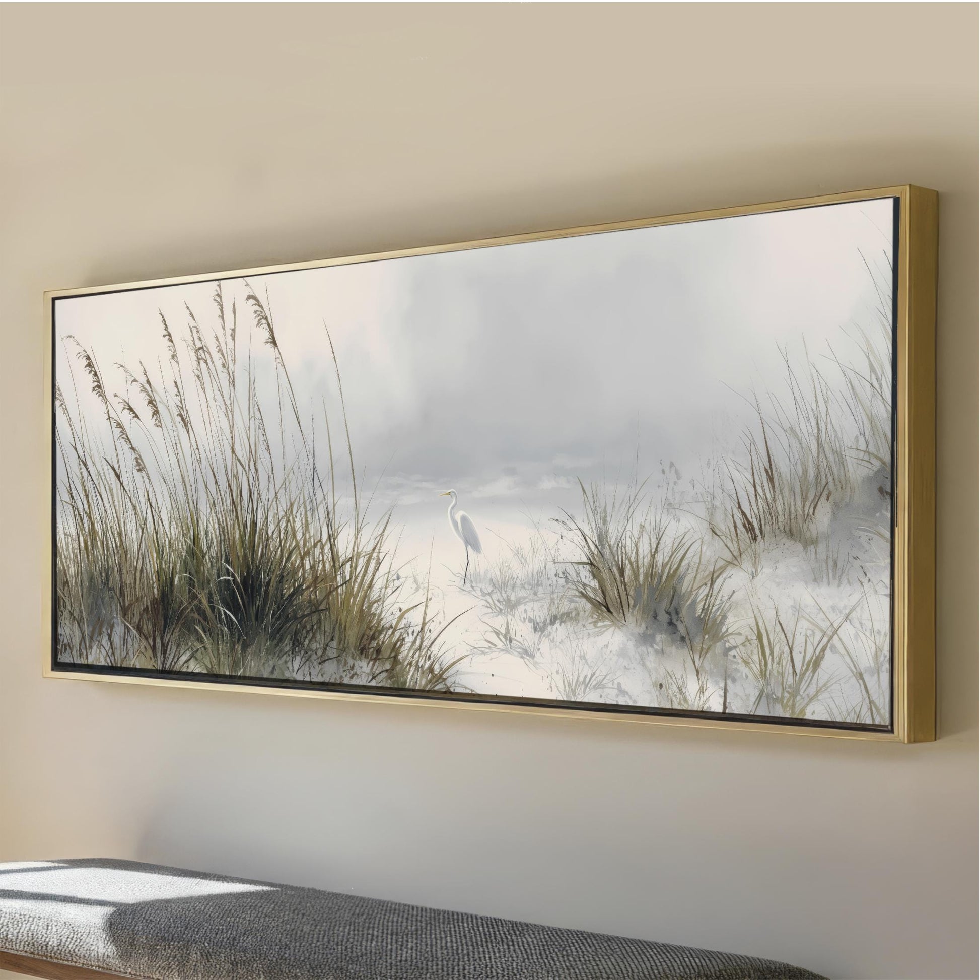 a large, framed painting depicting a serene landscape with tall grasses and a bird in the distance.