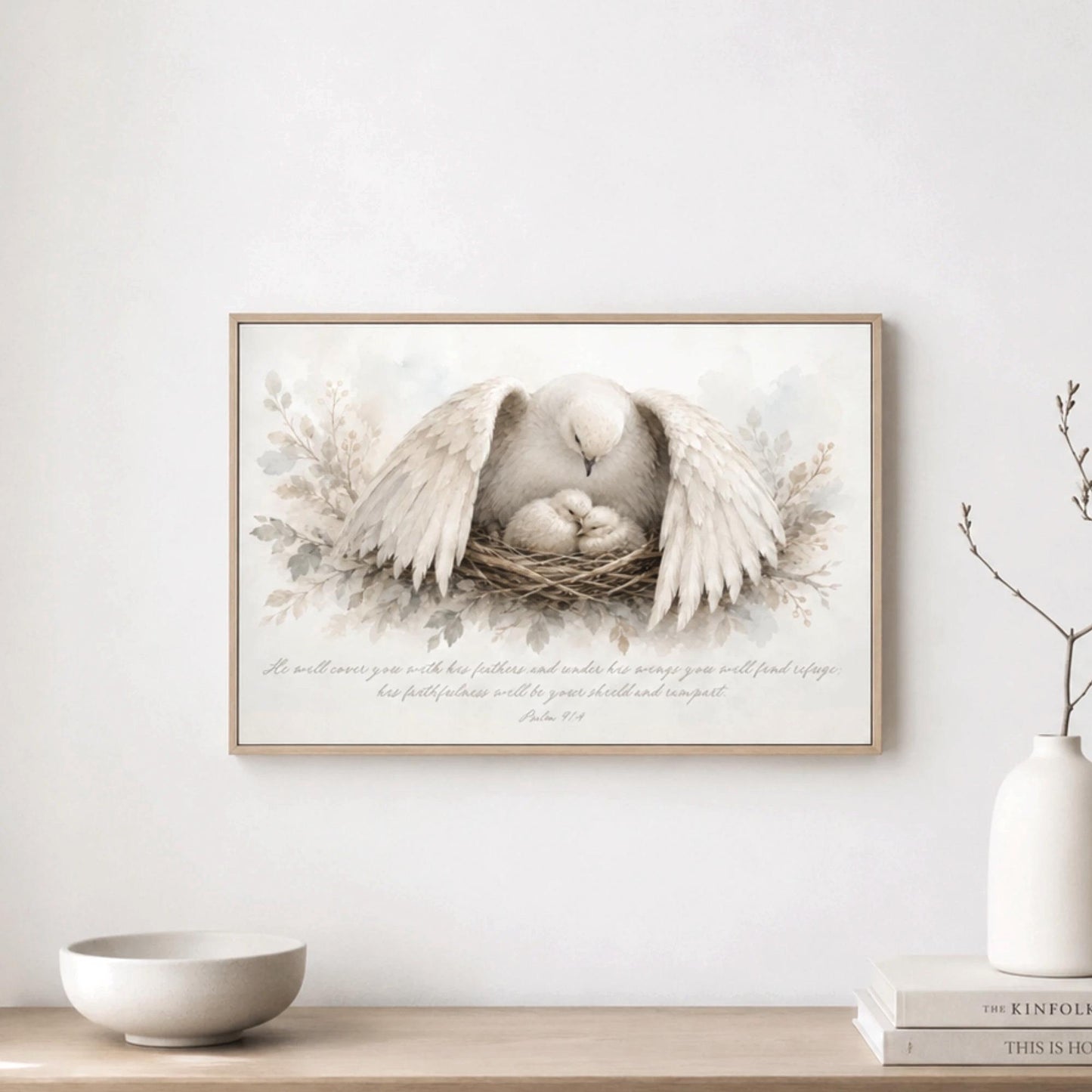 a framed painting of a white dove with its wings spread, sitting in a nest, with a text overlay that reads "It will cover you with its feathers and wings, and you will find shelter in its safety and warmth. His love will keep you safe and warm. His love will keep you safe and warm."