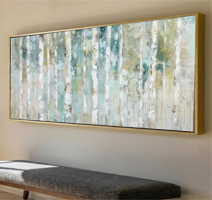 a large, abstract painting of a forest scene with tall trees and a mix of green, blue, and white colors. The painting is mounted on a wall above a gray bench, creating a cozy and inviting atmosphere in the room.