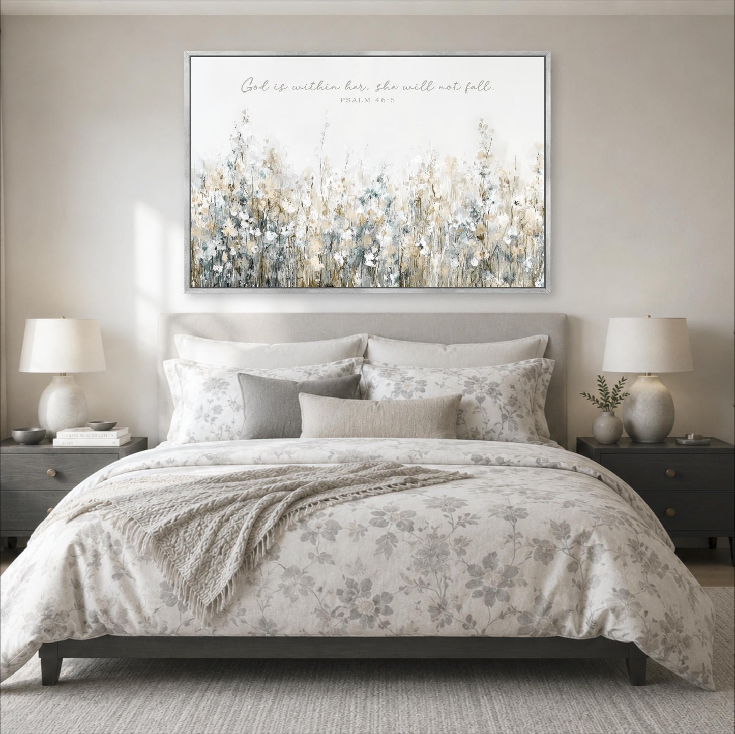 a serene bedroom scene with a large floral-patterned bed, a nightstand on each side, and a framed Bible verse on the wall above the bed.