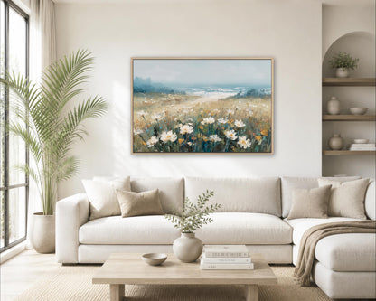 a serene living room with a large painting of a field of flowers hanging on the wall. The room is decorated with a white sofa, a coffee table, and a potted plant. The overall atmosphere of the room is calm and inviting, with the painting adding a touch of natural beauty to the space.
