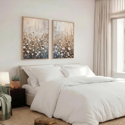 a serene and cozy bedroom with a large bed, white bedding, and two framed floral paintings on the wall above it.