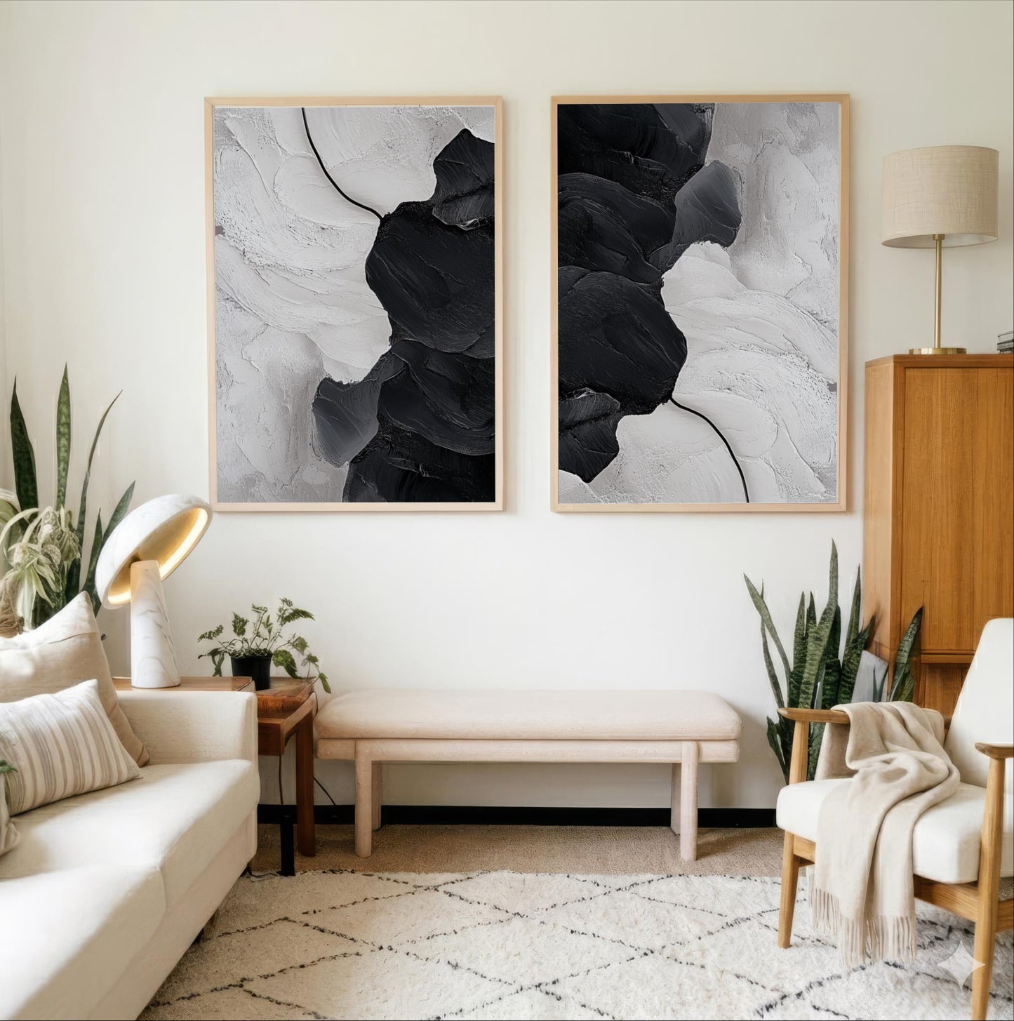 a modern living room with a white sofa, a wooden side table, and two framed abstract paintings on the wall.