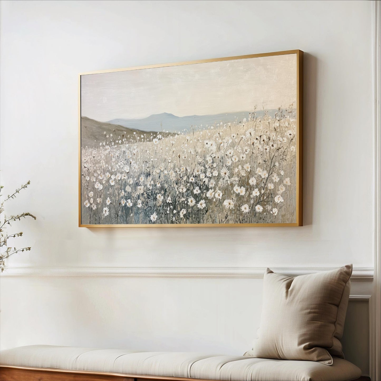 a large painting of a field of flowers hanging on a wall above a bench.