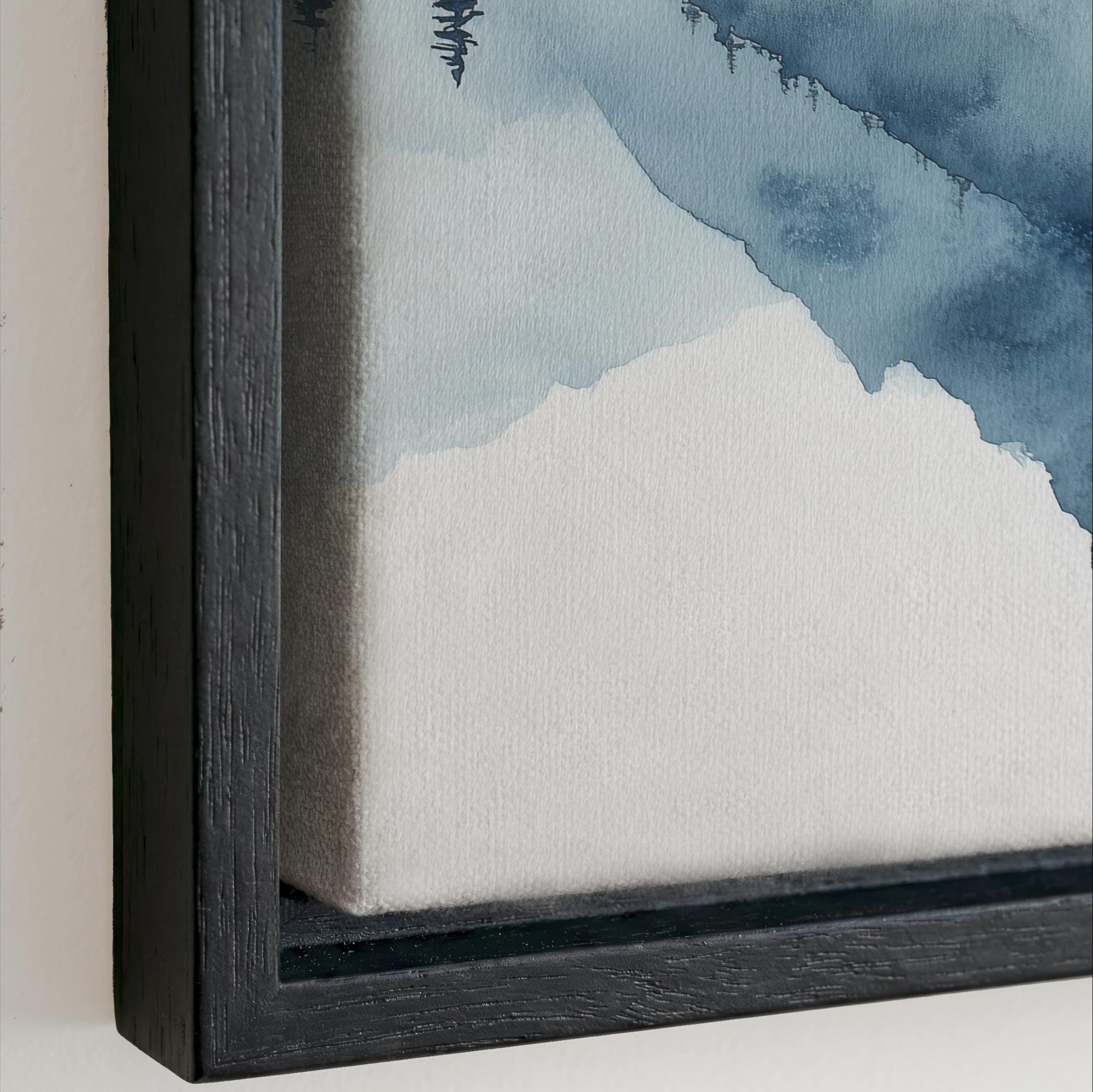 The image is a close-up of a framed painting depicting a landscape with mountains and a blue sky.