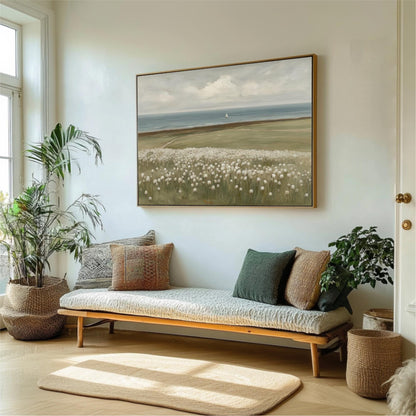 a living room with a large painting of a field of flowers hanging on the wall above a couch with pillows. The room is decorated with potted plants and a rug, creating a cozy and inviting atmosphere.