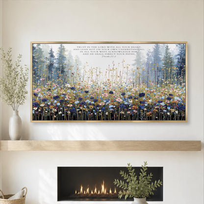 a large framed painting of a field of flowers hanging on a wall above a fireplace.