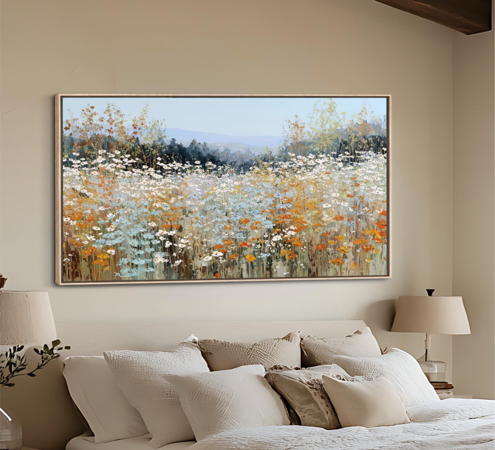 a large, framed painting of a field of flowers hanging on a wall above a bed with white bedding.