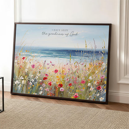 The image is a framed painting depicting a vibrant field of flowers with a serene body of water in the background.