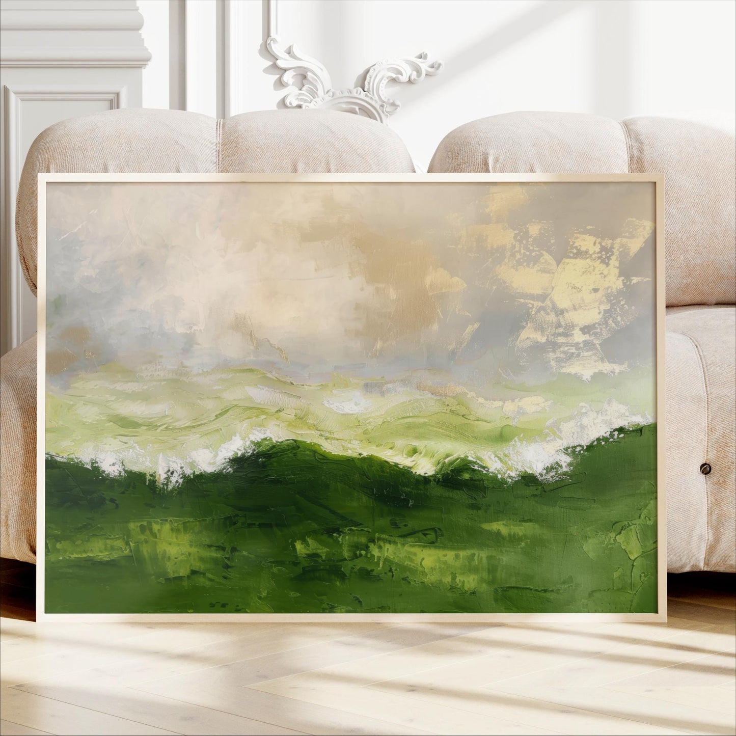 a large, framed painting of a landscape with green hills and a cloudy sky.