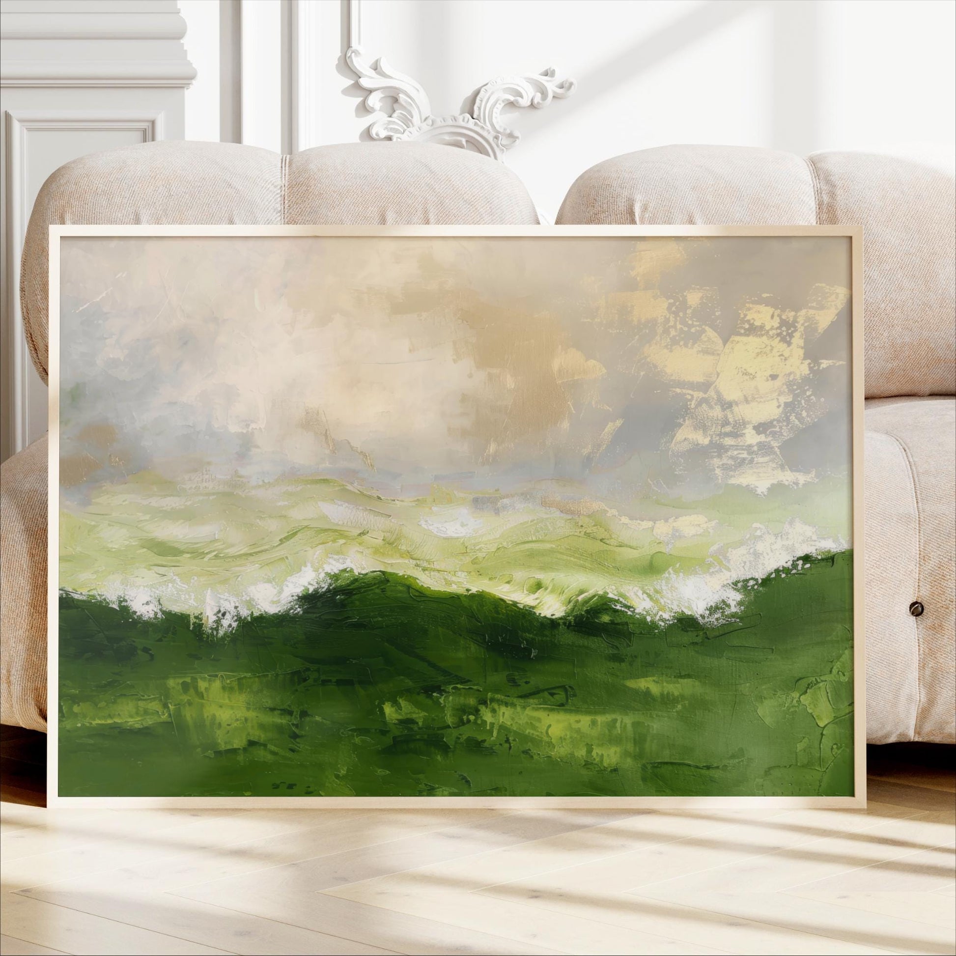 a large, framed painting of a landscape with green hills and a cloudy sky.