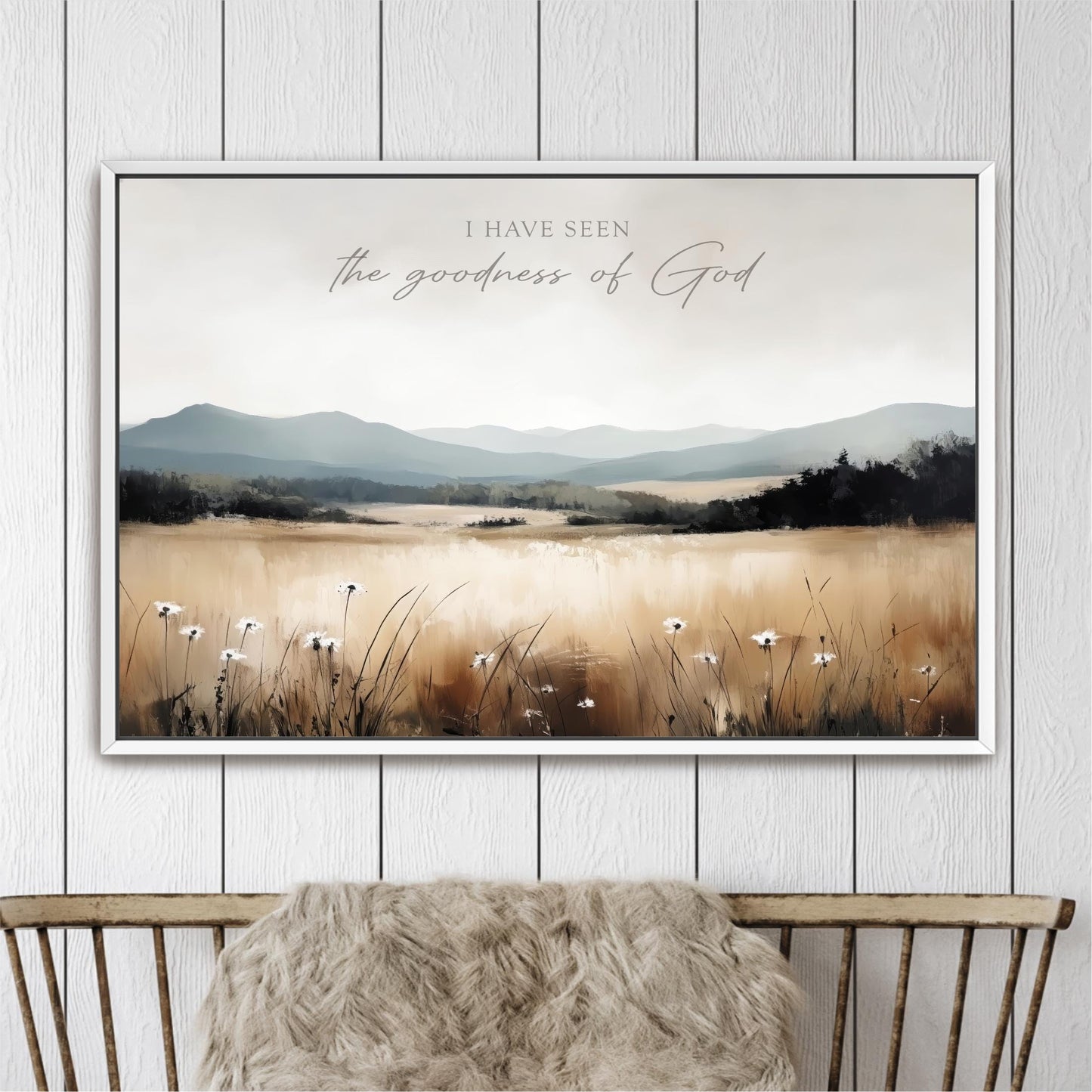 The image is a framed painting depicting a serene landscape with a field of flowers and mountains in the background.