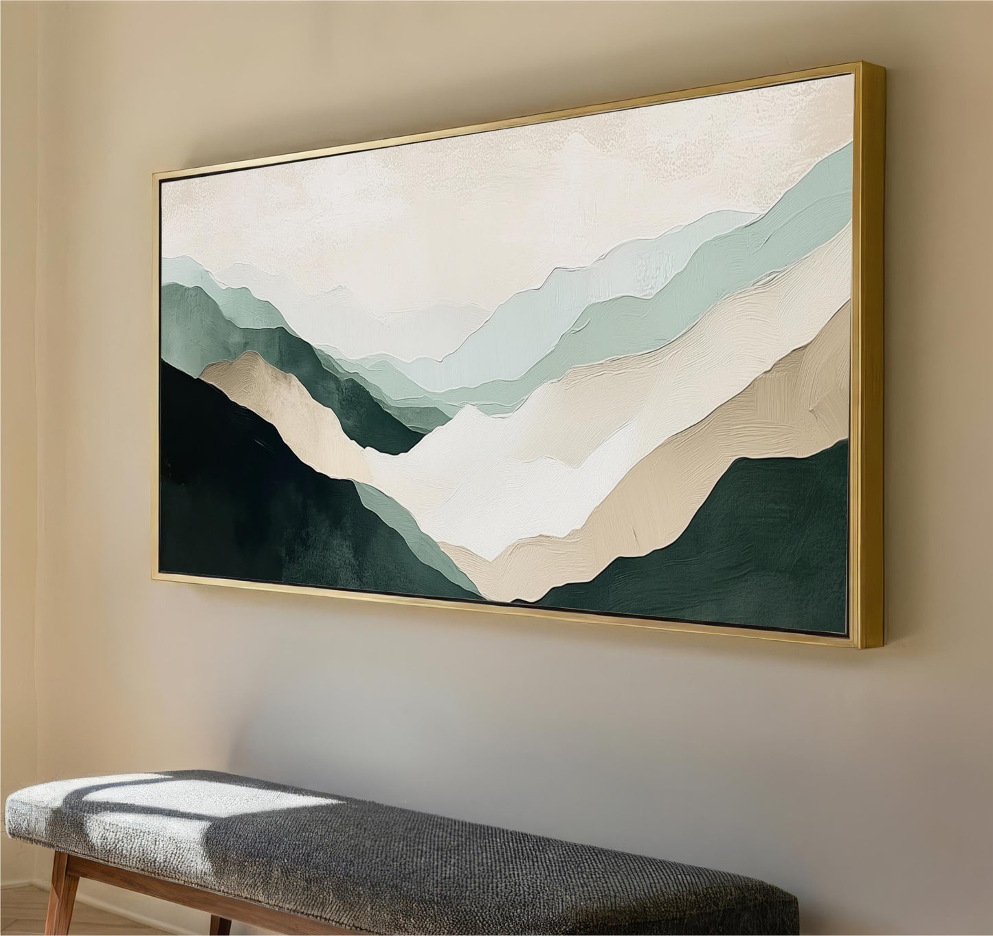 a large, framed painting of mountains hanging on a wall.