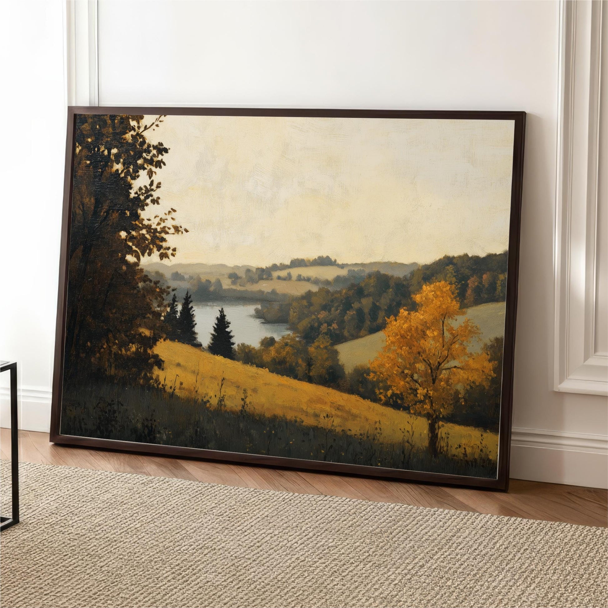 The image is a framed painting depicting a serene landscape with a tree in the foreground, a river in the background, and rolling hills in the distance.