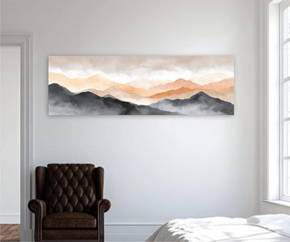 a large landscape painting hanging on a white wall, depicting a mountain range with a hazy, golden-orange sky above. In the foreground, there is a brown leather armchair, and a white bed can be seen in the background.