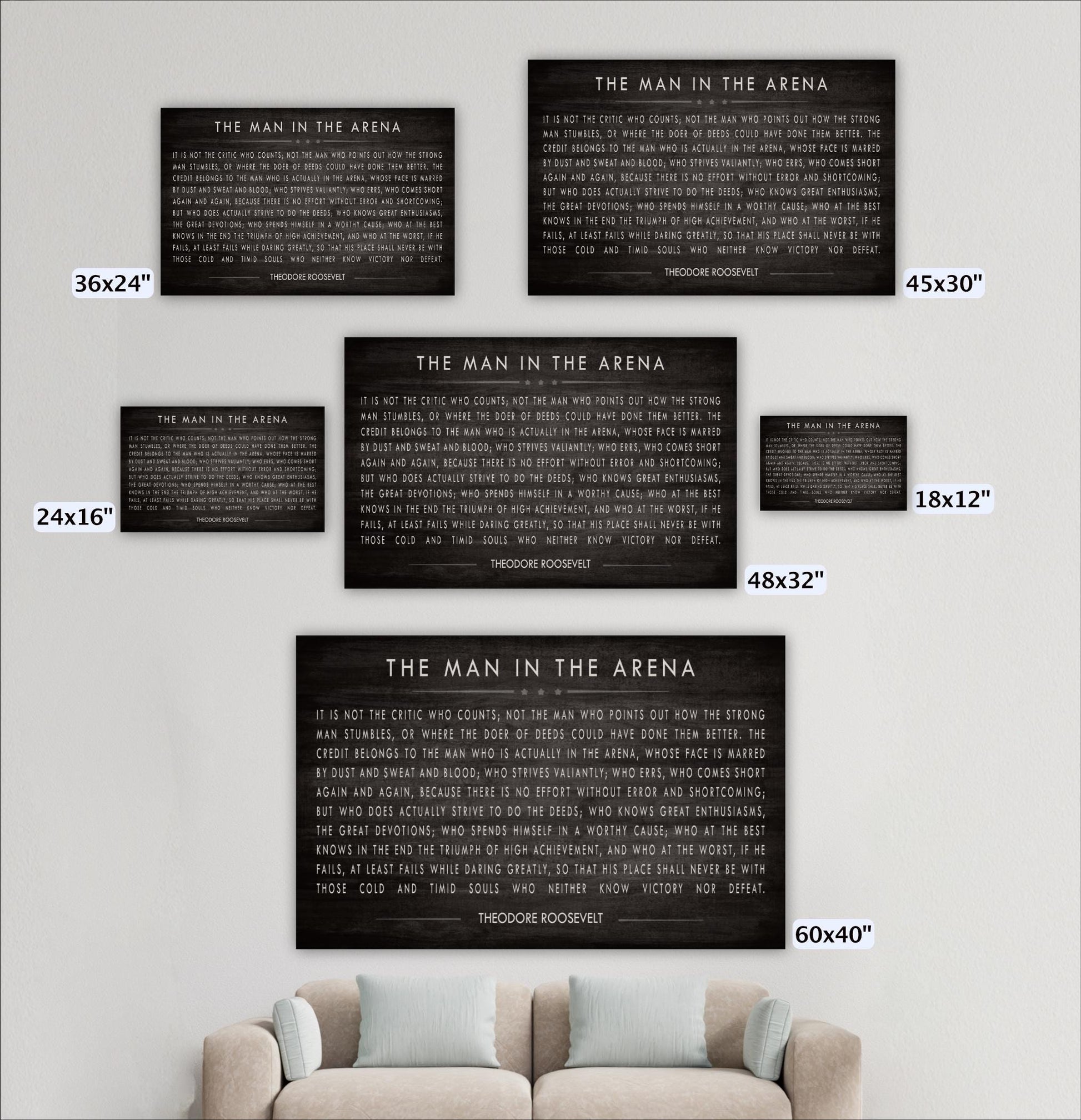 a collection of five black and white posters or wall art pieces, each with a different title or message, displayed on a wall above a couch.