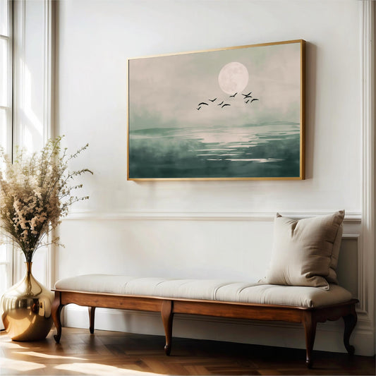 a serene indoor setting with a large painting of a tranquil landscape hanging on the wall, a wooden bench with a white cushion, and a vase of white flowers on the floor.