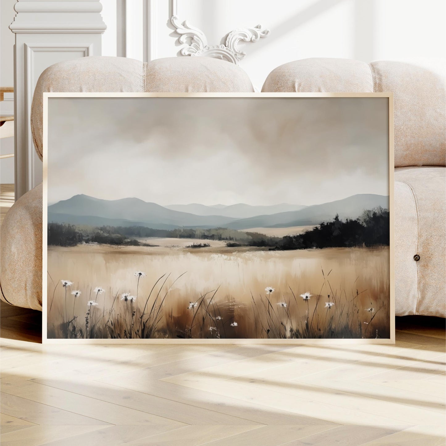 a framed painting of a serene landscape with a field of tall grass and wildflowers, set against a backdrop of mountains and a cloudy sky.