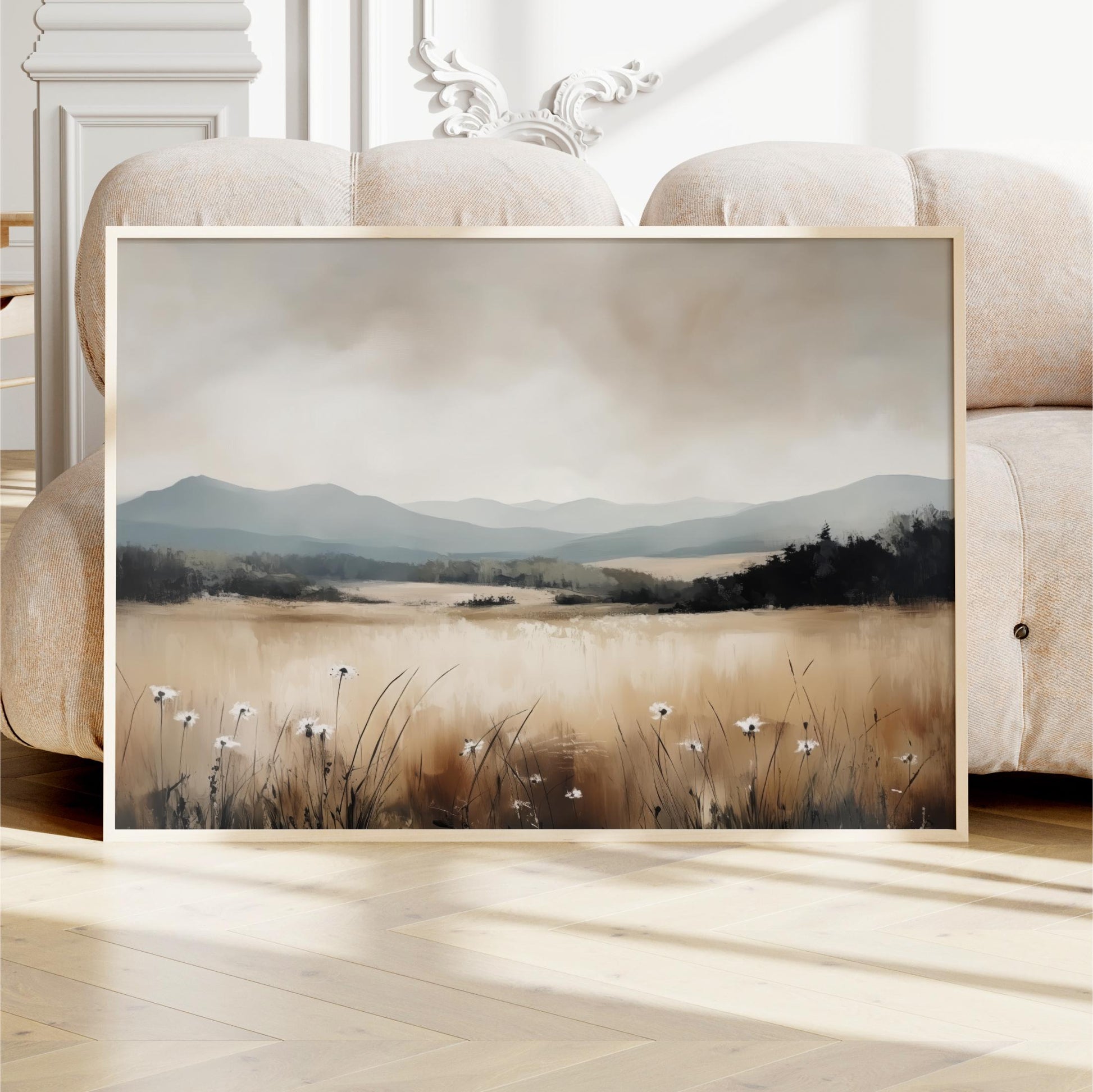 a framed painting of a serene landscape with a field of tall grass and wildflowers, set against a backdrop of mountains and a cloudy sky.