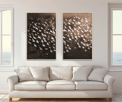 a cozy living room with a white sofa and two framed artworks hanging on the wall. The artworks depict a flock of birds in various shades of brown and white, creating a dynamic and visually appealing composition.