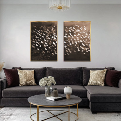 a modern living room with a gray sectional sofa, a round coffee table, and two framed artworks of birds on the wall.