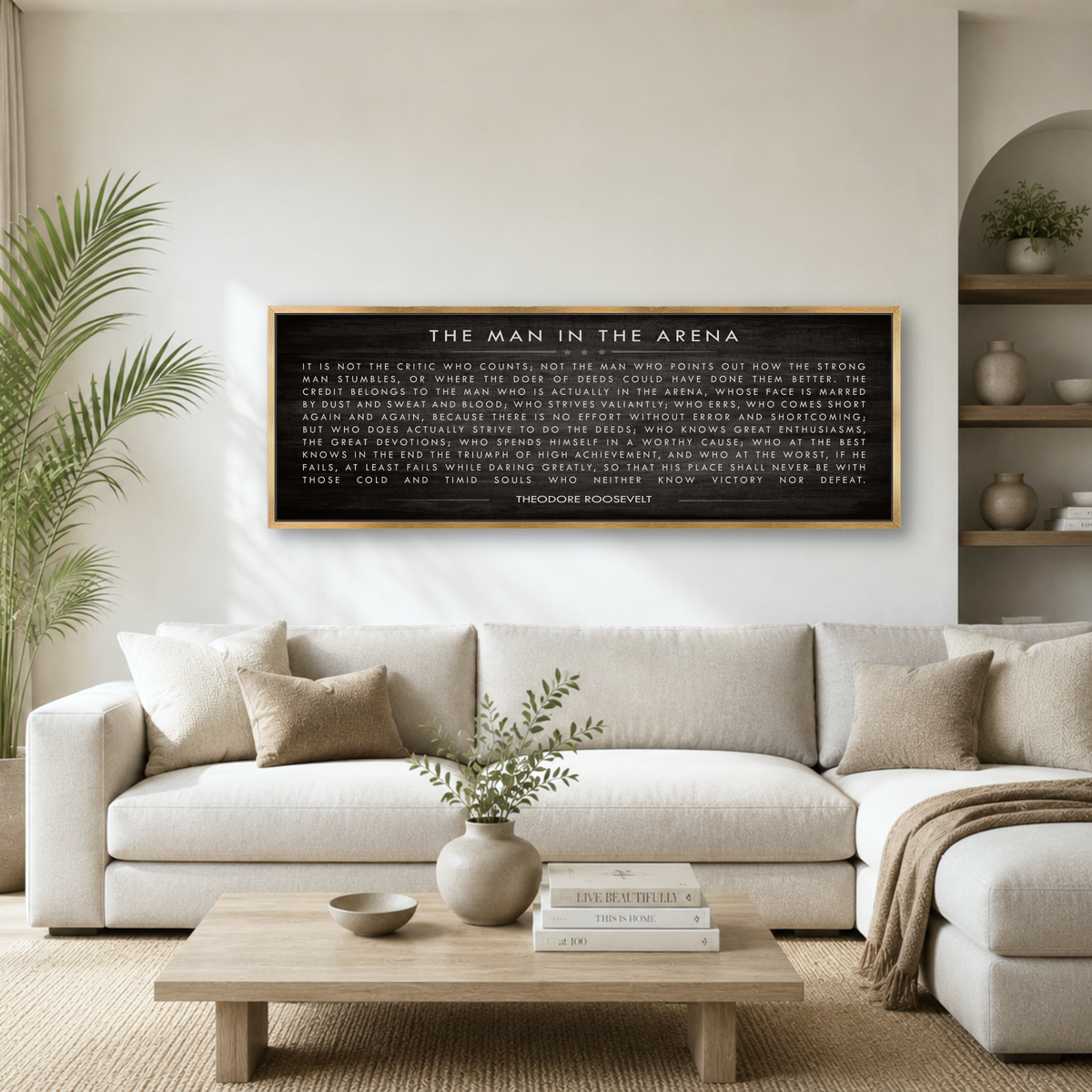 a living room with a white sofa, a wooden coffee table, and a framed quote on the wall above it.