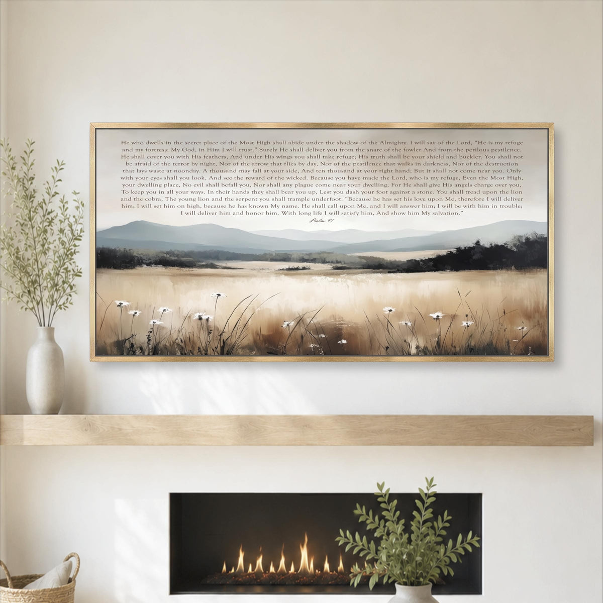 a framed painting of a serene landscape with a field of tall grass and a distant mountain range, hanging on a wall above a fireplace.