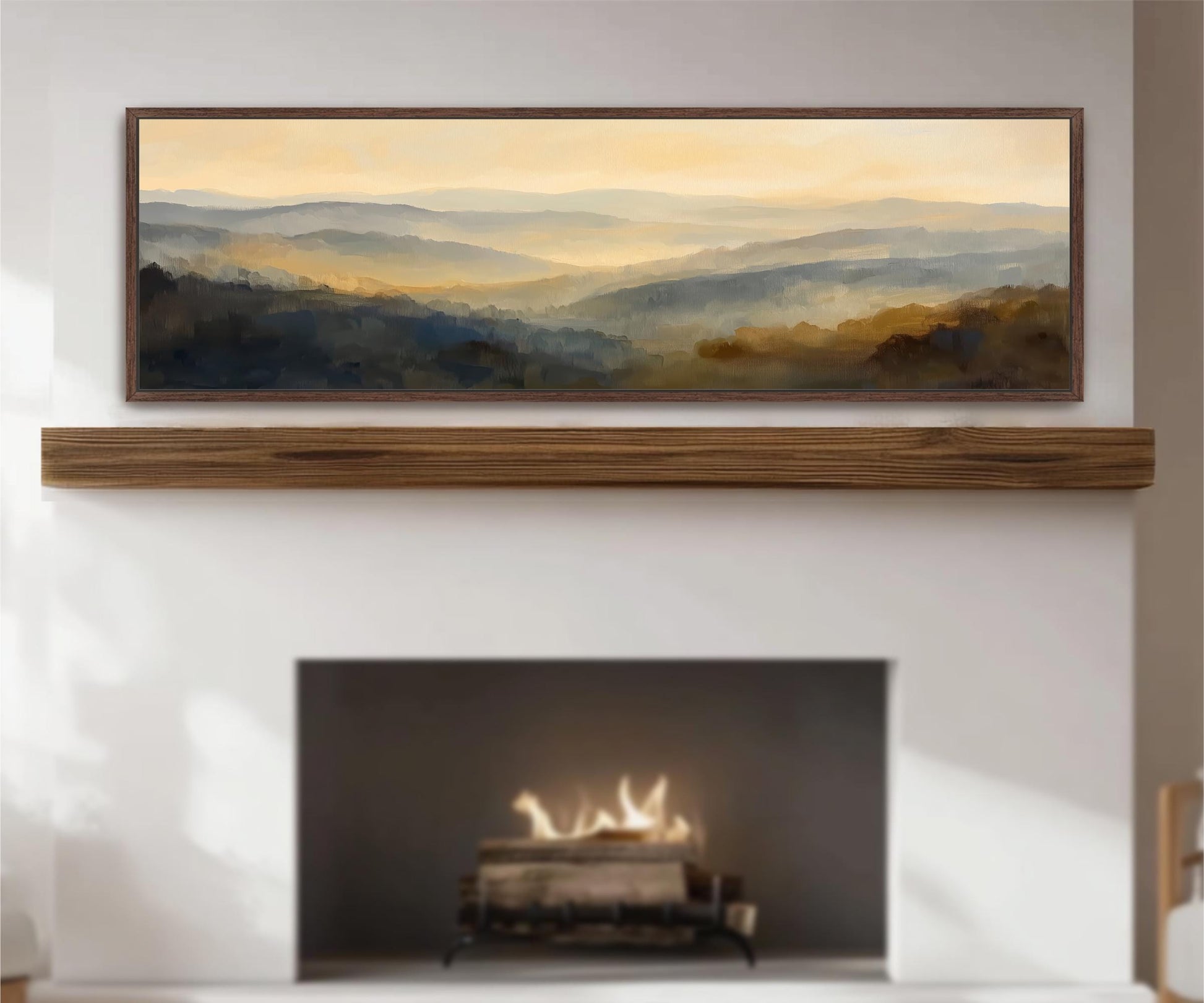 a fireplace with a warm fire burning inside, creating a cozy atmosphere. Above the fireplace, there is a framed painting depicting a scenic mountain landscape with a hazy, golden-hued sky.