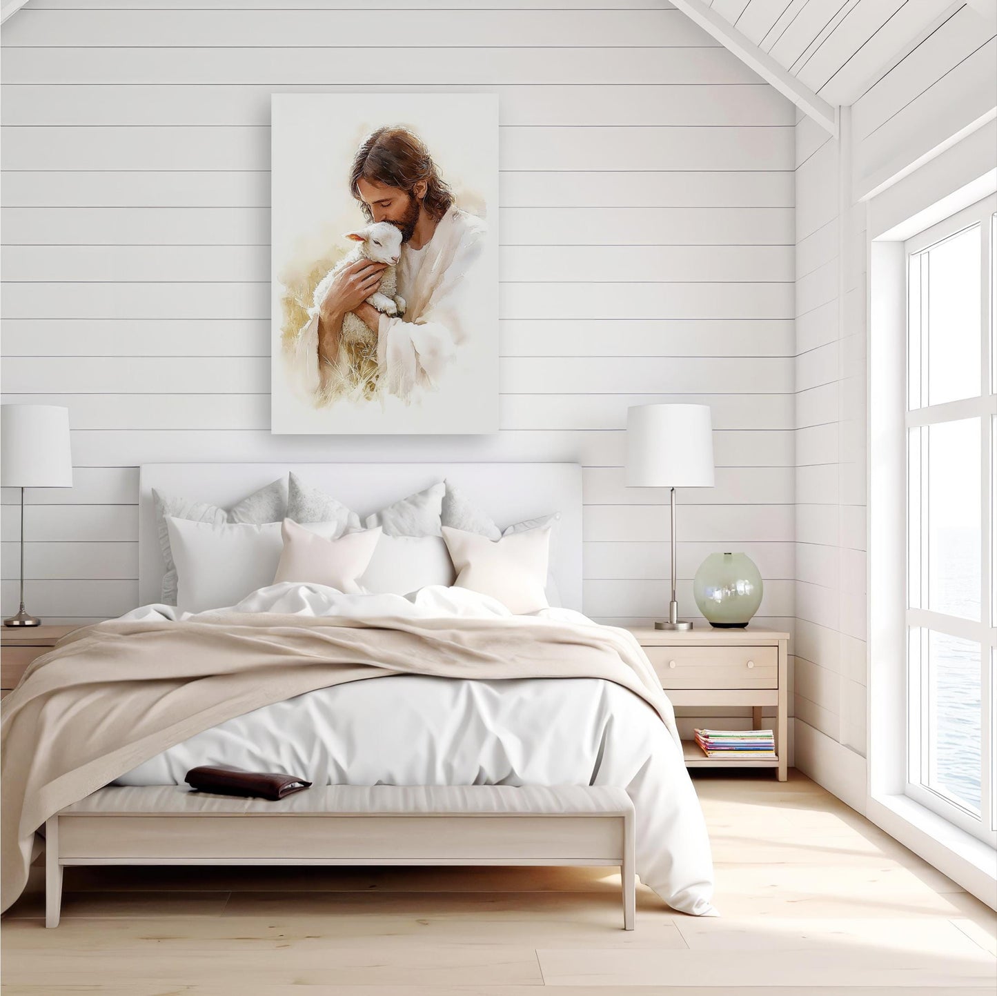 a serene bedroom scene with a large bed, white bedding, and a framed painting of Jesus holding a lamb hanging on the wall above the bed.