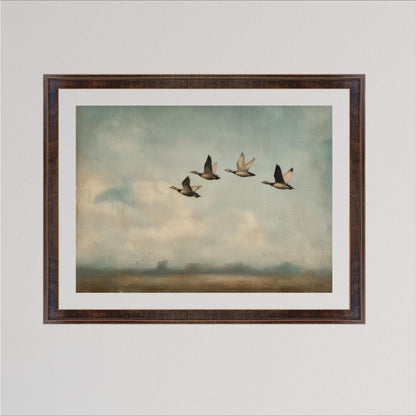 A framed painting depicting four ducks flying in a line across a cloudy sky.